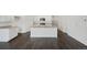 Bright open kitchen with island, stainless appliances, and wood-look floors at 770 N Deer Park St, Watkins, CO 80137