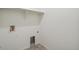 Compact laundry room with connections for a washer and dryer and overhead shelf at 770 N Deer Park St, Watkins, CO 80137