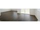 Open living room with luxury vinyl plank flooring and plenty of natural light at 770 N Deer Park St, Watkins, CO 80137
