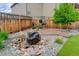 Landscaped backyard features a rock water feature, string lights, and patio with seating at 6899 Petunia Pl, Castle Rock, CO 80108