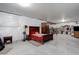 Unfinished basement area with bed, dressers, and exposed walls at 6899 Petunia Pl, Castle Rock, CO 80108