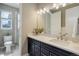 Bathroom with a shower, toilet and vanity with white countertop at 6899 Petunia Pl, Castle Rock, CO 80108