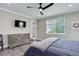 Comfortable bedroom offers natural light, hardwood floors, dresser, and decor at 6899 Petunia Pl, Castle Rock, CO 80108