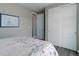 Cozy bedroom features hardwood floors and closet with sliding doors at 6899 Petunia Pl, Castle Rock, CO 80108