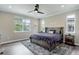 This bedroom features a ceiling fan, recessed lights, and natural light from the windows for a comfortable living space at 6899 Petunia Pl, Castle Rock, CO 80108
