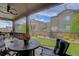 Inviting screened-in patio features a ceiling fan, outdoor seating, and views of the backyard at 6899 Petunia Pl, Castle Rock, CO 80108