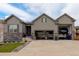 Beautiful home exterior with large multi-car garage and well maintained lawn and landscaping at 6899 Petunia Pl, Castle Rock, CO 80108