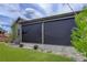 Exterior of the home featuring a screened-in patio and manicured lawn at 6899 Petunia Pl, Castle Rock, CO 80108