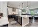 Bright kitchen featuring stainless steel appliances, white cabinets, and an open concept design at 6899 Petunia Pl, Castle Rock, CO 80108