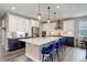 Modern kitchen with stainless steel appliances, white cabinets, and a large center island at 6899 Petunia Pl, Castle Rock, CO 80108