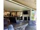 Open living room with a fireplace and a seamless indoor-outdoor transition with sliding glass doors to the patio at 6899 Petunia Pl, Castle Rock, CO 80108