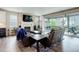 Comfortable living room features a fireplace, large windows and sliding doors that open to the covered patio at 6899 Petunia Pl, Castle Rock, CO 80108