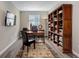 Bright home office with hardwood floors, well organized bookshelf, and lots of light at 6899 Petunia Pl, Castle Rock, CO 80108
