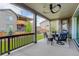 An outdoor patio with a ceiling fan, string lights, comfortable seating, and a well-maintained backyard at 6899 Petunia Pl, Castle Rock, CO 80108