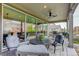 A cozy covered patio with a dining table and chairs, ceiling fan, string lights, and a view of the backyard at 6899 Petunia Pl, Castle Rock, CO 80108