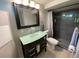Stylish bathroom with a modern vanity, glass basin sink, and walk-in shower at 3993 Haddon Rd, Denver, CO 80205