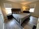 Serene bedroom featuring a large bed, dark wood accents, and ample natural light at 3993 Haddon Rd, Denver, CO 80205