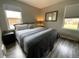 Comfortable bedroom with two windows, a large bed, and stylish decor at 3993 Haddon Rd, Denver, CO 80205