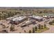 Aerial view of a shopping center with neatly arranged parking, lush trees, and a backdrop of mountains at 7010 Homeplace Pt, Castle Rock, CO 80108