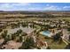 Stunning aerial view of a community with a pond, pool, green spaces, and meticulously designed homes at 7010 Homeplace Pt, Castle Rock, CO 80108