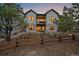 Backyard view featuring a covered patio, balcony, and a wooden fence at 7010 Homeplace Pt, Castle Rock, CO 80108