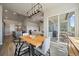 Open concept dining room with wooden table and chairs, leading to outdoor patio seating at 7010 Homeplace Pt, Castle Rock, CO 80108