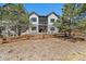 Two-story home featuring a patio on the first level and a balcony on the second, overlooking a lush green landscape at 7010 Homeplace Pt, Castle Rock, CO 80108