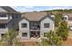 Two-story home with a patio on the first level and a balcony on the second, perfect for enjoying mountain views at 7010 Homeplace Pt, Castle Rock, CO 80108