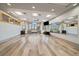 Bright fitness studio with wood floors, mirrored wall, large windows, and ceiling fans for a comfortable workout space at 7010 Homeplace Pt, Castle Rock, CO 80108