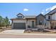 Charming home with a well-manicured lawn, inviting entrance, and attached garage at 7010 Homeplace Pt, Castle Rock, CO 80108