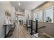 Hallway view features wood flooring, stylish decor, and an open view to the living areas at 7010 Homeplace Pt, Castle Rock, CO 80108