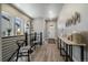 Bright hallway with wood floors, artful decor, and staircase at 7010 Homeplace Pt, Castle Rock, CO 80108