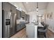 Modern kitchen with stainless steel appliances, ample counter space, and stylish pendant lights at 7010 Homeplace Pt, Castle Rock, CO 80108