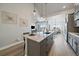 Spacious kitchen island with pendant lighting and views into the living and dining spaces at 7010 Homeplace Pt, Castle Rock, CO 80108