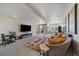 Spacious basement living area featuring a sectional sofa, large TV, and sliding glass door to the outside at 7010 Homeplace Pt, Castle Rock, CO 80108