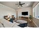 Comfortable living room with ceiling fan, modern furniture, and view out of three large windows at 7010 Homeplace Pt, Castle Rock, CO 80108
