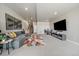 Basement living room with a gray sectional sofa, colorful rug, and entertainment center at 7010 Homeplace Pt, Castle Rock, CO 80108
