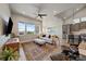 Open-concept living room with plenty of natural light and wood flooring at 7010 Homeplace Pt, Castle Rock, CO 80108