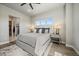 Well-lit main bedroom with neutral tones, soft bedding, and a modern design at 7010 Homeplace Pt, Castle Rock, CO 80108