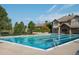 Inviting outdoor swimming pool featuring clear blue water, marked lanes, and nearby lounge seating at 7010 Homeplace Pt, Castle Rock, CO 80108