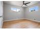 Light-filled bedroom featuring hardwood floors and a ceiling fan at 181 E 108Th Ave, Northglenn, CO 80233