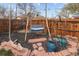 Cozy backyard with wooden fence, swing and decorative planters. Perfect for relaxation and outdoor enjoyment at 1891 S Madison St, Denver, CO 80210