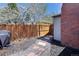 Cozy backyard with stone paver pathway, wood fence, and blooming trees, creating a private outdoor space at 1891 S Madison St, Denver, CO 80210