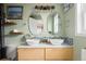 Light green bathroom with dual vessel sinks, unique mirrors, and an open, airy feel at 1891 S Madison St, Denver, CO 80210