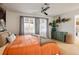 Bright bedroom featuring an orange comforter, wood floors, neutral walls, and a green dresser at 1891 S Madison St, Denver, CO 80210