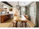 Spacious dining area with a rustic table, bench seating, and modern lighting at 1891 S Madison St, Denver, CO 80210