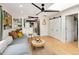 Bright living room showcases a comfortable gray sofa, view of updated kitchen, and sliding door at 1891 S Madison St, Denver, CO 80210