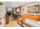 An office with a brick fireplace, desk, hardwood floors, colorful rug, and a daybed at 1891 S Madison St, Denver, CO 80210