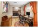 Office with a brick fireplace, desk, hardwood floors, colorful rug, and an eye-catching colorful painting at 1891 S Madison St, Denver, CO 80210