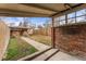 Cozy backyard featuring a covered patio and shed with a concrete walkway and grass at 2515 Ames St, Edgewater, CO 80214